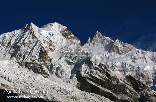 Forked Peak (L) and Mt. Kangchenjunga shining in bright white sunlight