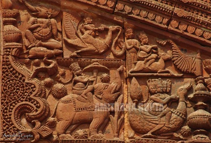 An array of Gods in terracotta panels. From left, top row: Ganesha on mouse, Vishnu on Garuda, Vayu on Deer, bottom row:  Indra on an elephant, Brahma on swan